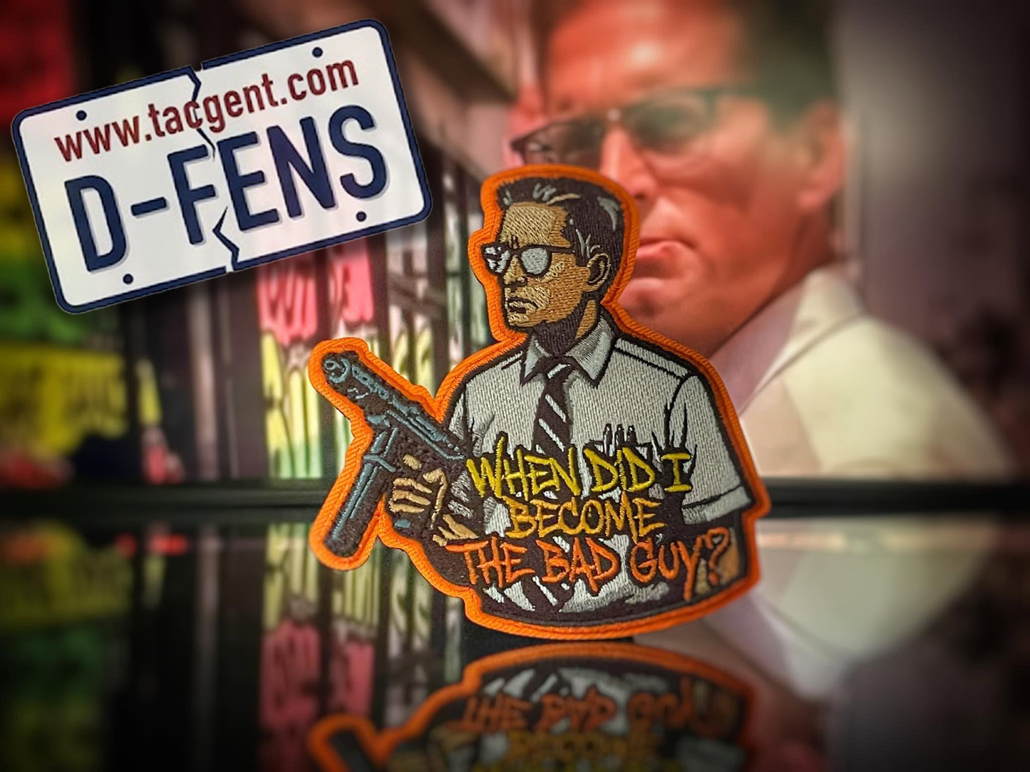 Patch with text 'When did I become the bad guy?' and a website URL on a reflective surface.