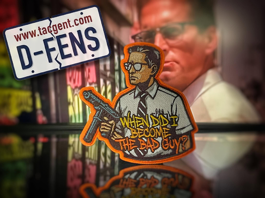 Patch with text 'When did I become the bad guy?' and a website URL on a reflective surface.